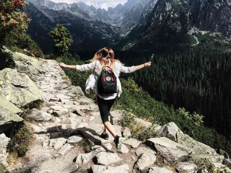 Woman exploring on the top of a cliff