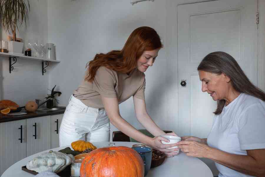 Mother and daughter in kitchen around table