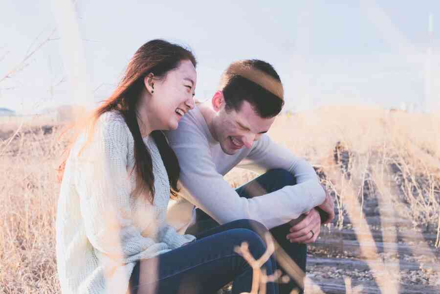 A woman and a man laughing together