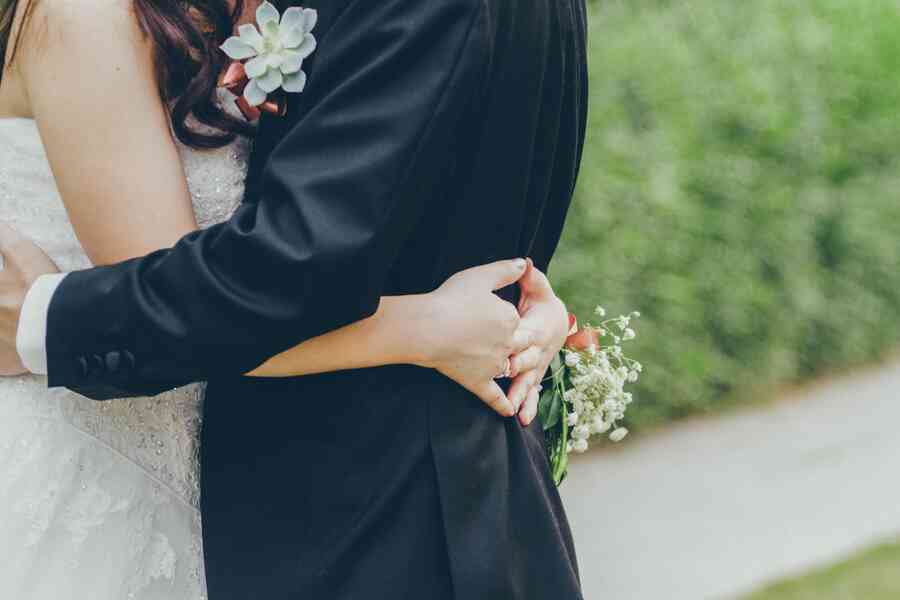 A bride and groom hugging.