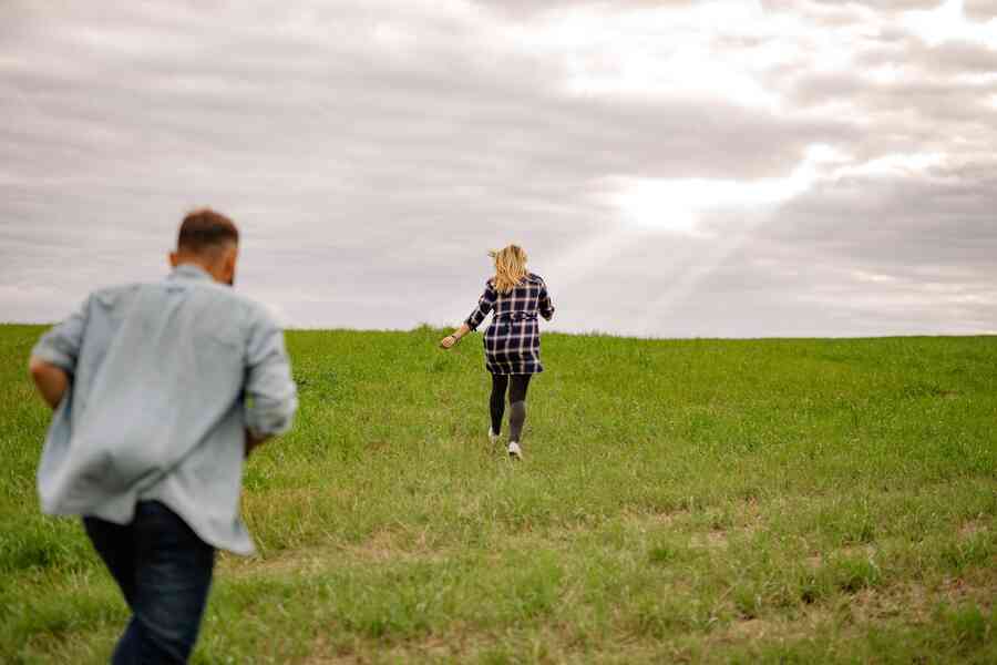 Man and woman running through a field