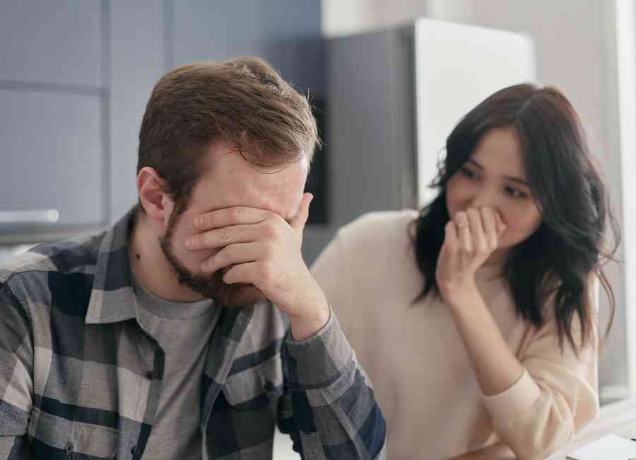 A moody or upset man next to a friend