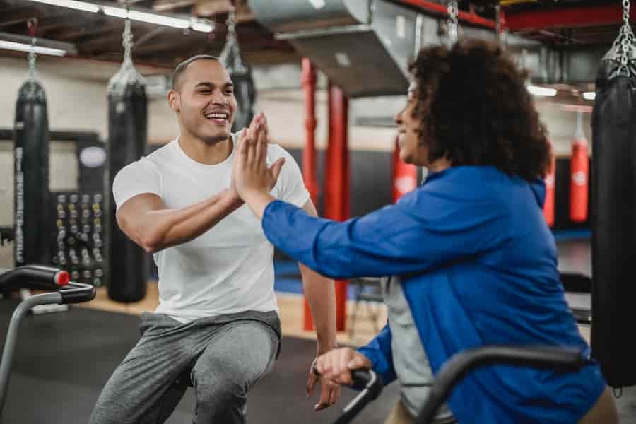 Gym partners high five each other