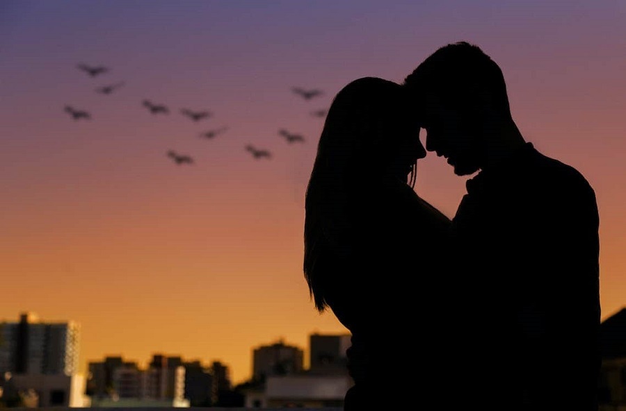 Silhouette of couple holding each other